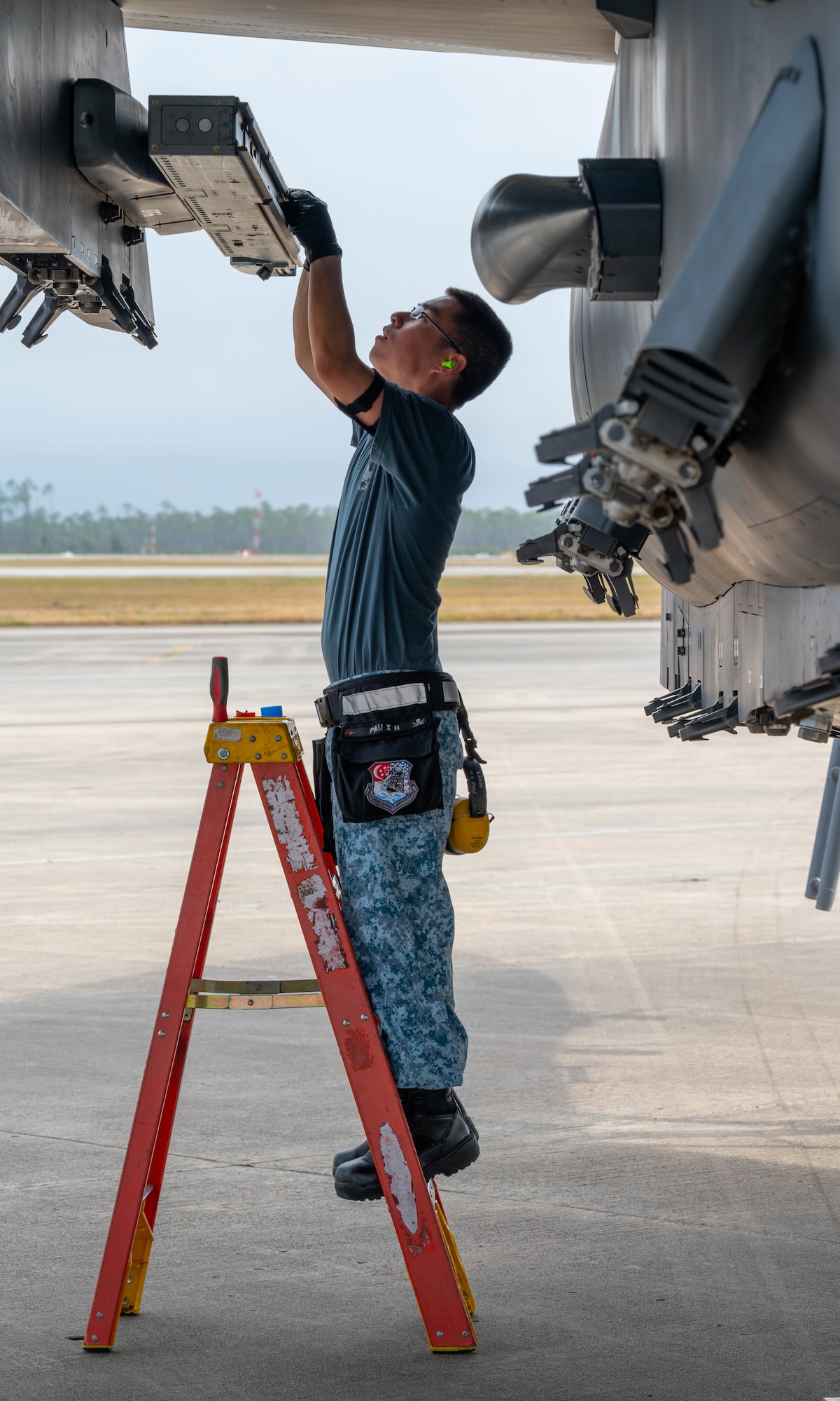 An airman performs an aircraft inspection