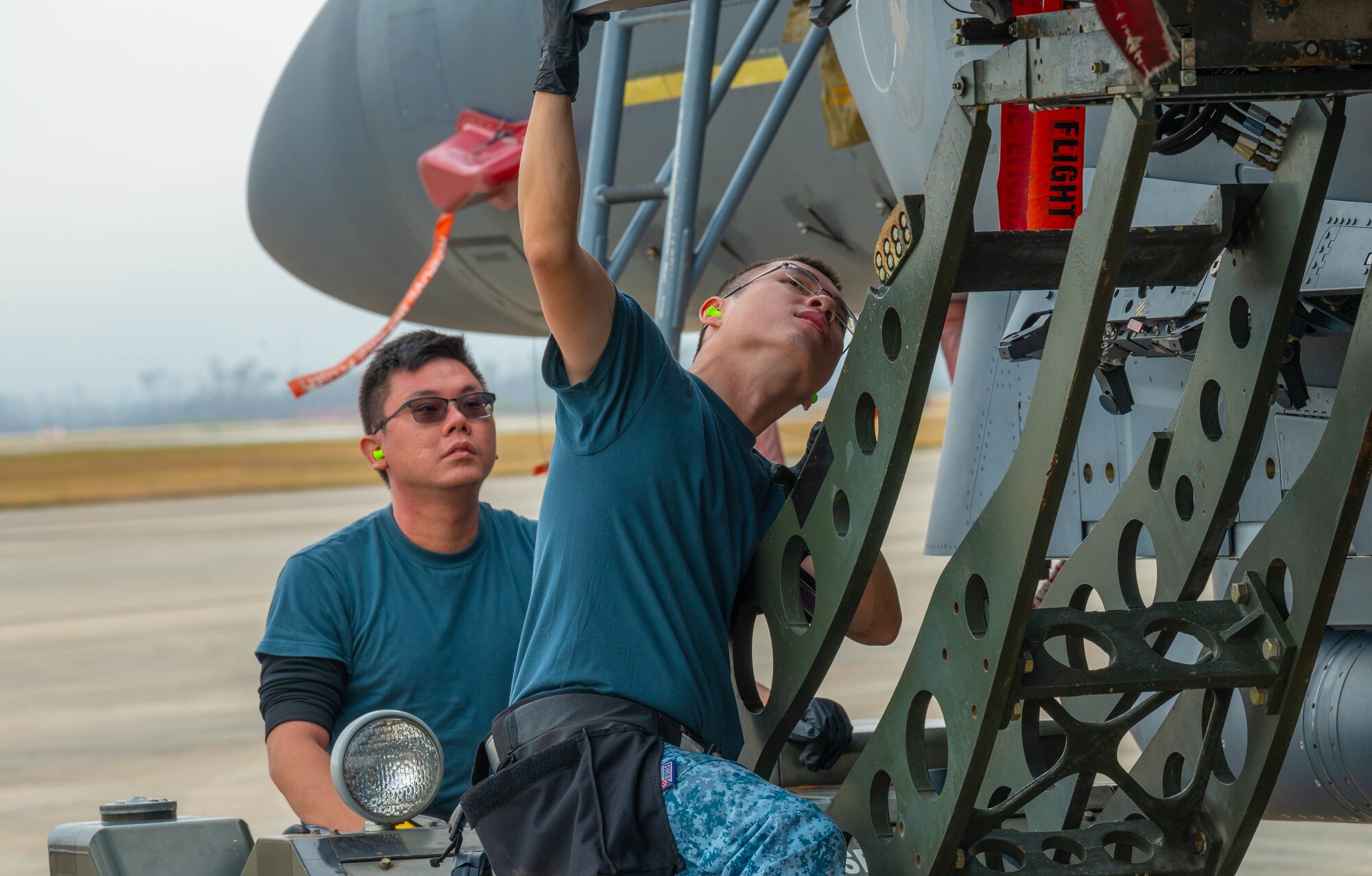 An airman load a missile onto an aircraft