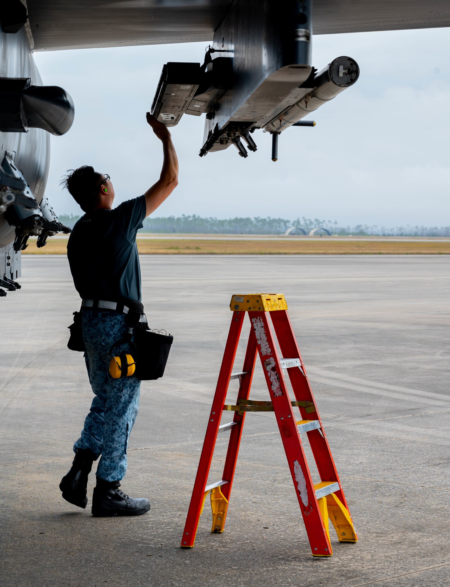 An airman performs a aircraft inspection