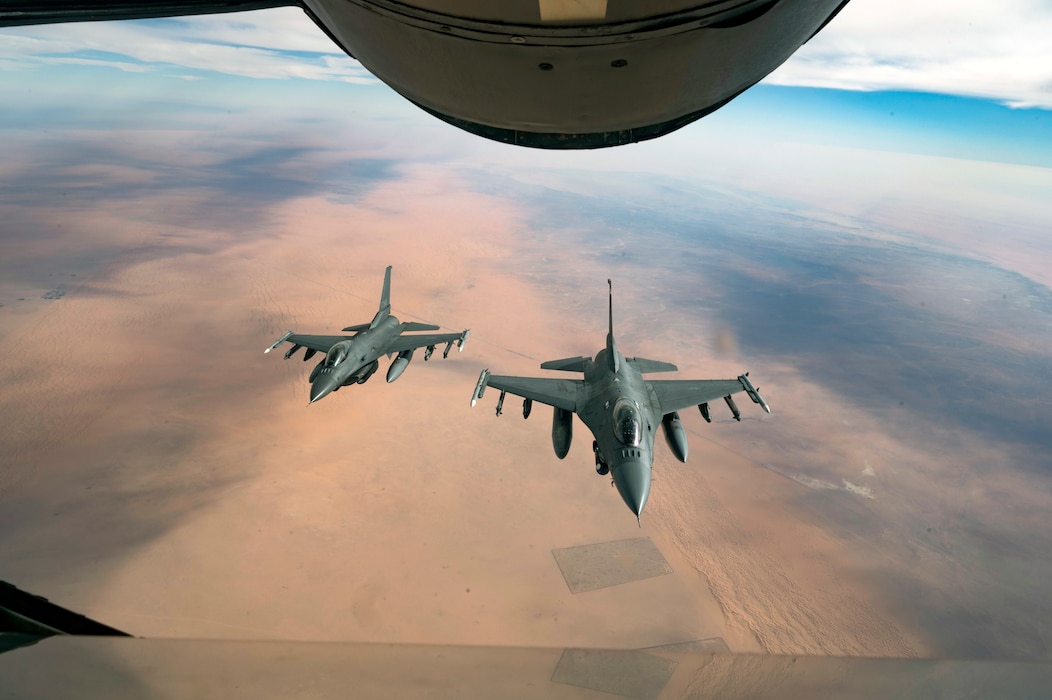 U.S. Air Force F-16 Fighting Falcons fly in formation behind a U.S. Air Force KC-135 Stratotanker