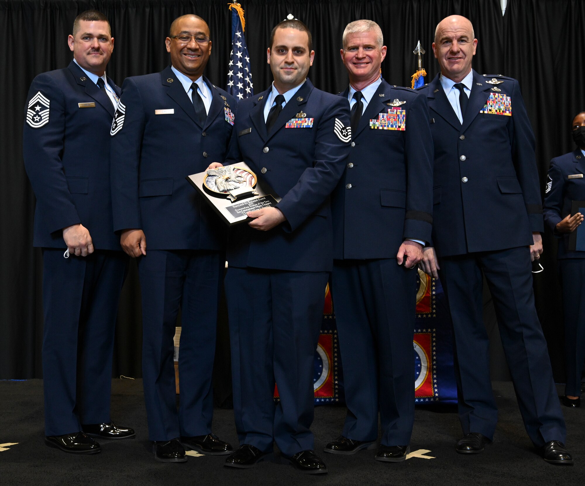 U.S. Air Force Tech. Sgt. Matthew Harbin, 175th Wing Noncommissioned officer of the Year, Maryland Air National Guard, receives a plaque at Warfield Air National Guard Base, Middle River, Md., during the 2021 Airman Recognition Ceremony. The yearly event pays tribute to the outstanding achievements of the Maryland Air National Guard and names the wing's outstanding Airman of the year. (U.S. Air National Guard photo by Amn Alexandra Huettner)