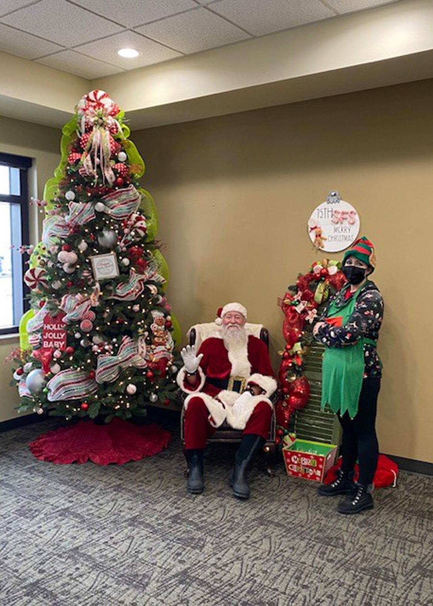 Santa and his elf during the 75th Security Forces Squadron Cookies with Santa social Dec. 12, 2021, at Hill Air Force Base, Utah. The event was arranged by key spouses to spread holiday cheer to the unit’s Defenders and their families. (Courtesy photo)