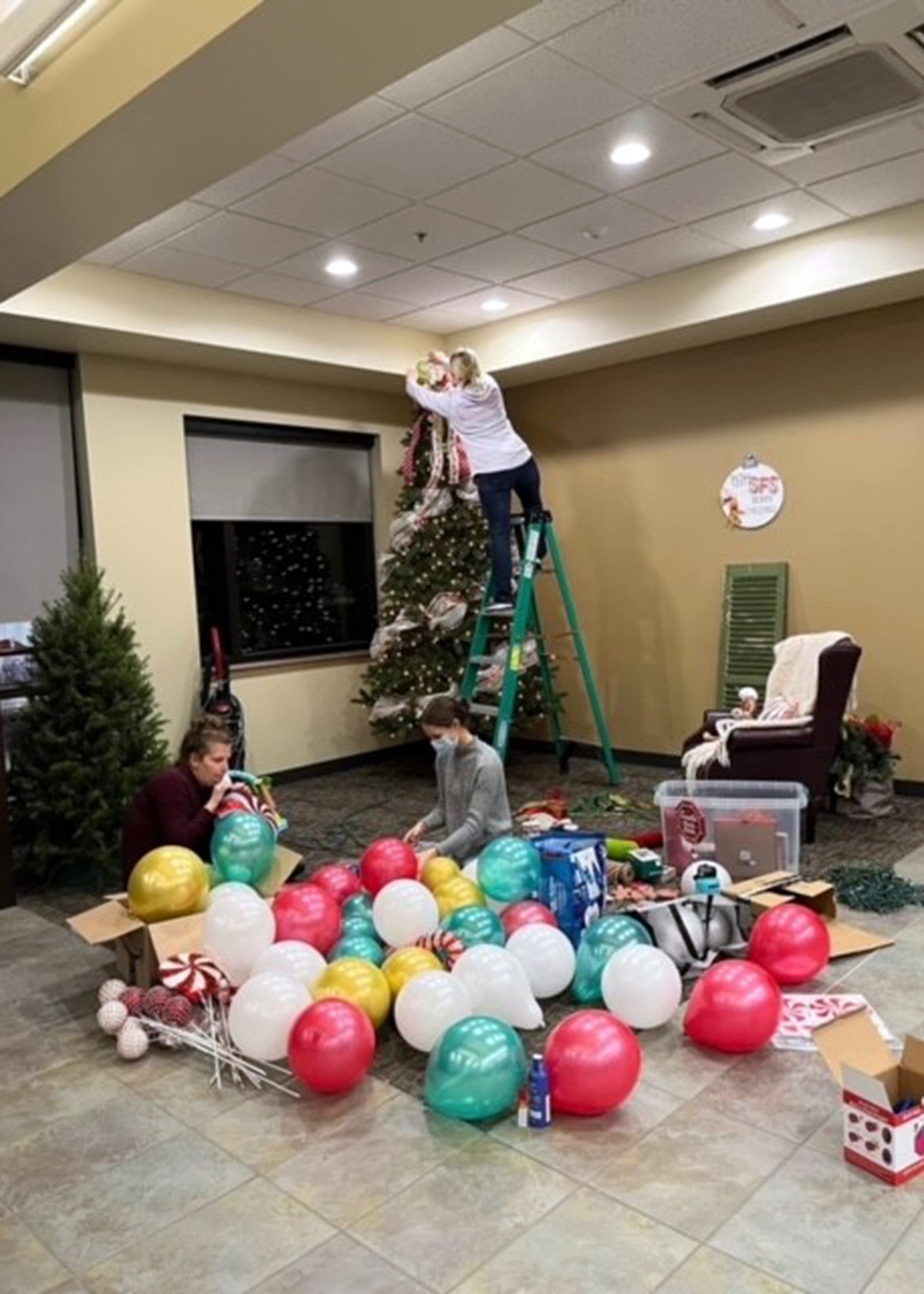(Left to right) Brittany Baca, Abby Brumbeloe and Trish Dinkins, all key spouses for 75th Security Forces Squadron, decorate for a Cookies with Santa social Dec. 12, 2021, at Hill Air Force Base, Utah. The event was arranged by key spouses to spread holiday cheer to the unit’s Defenders and their families. (Courtesy photo)