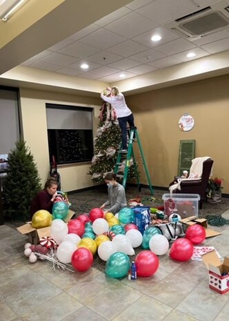 (Left to right) Brittany Baca, Abby Brumbeloe and Trish Dinkins, all key spouses for 75th Security Forces Squadron, decorate for a Cookies with Santa social Dec. 12, 2021, at Hill Air Force Base, Utah. The event was arranged by key spouses to spread holiday cheer to the unit’s Defenders and their families. (Courtesy photo)