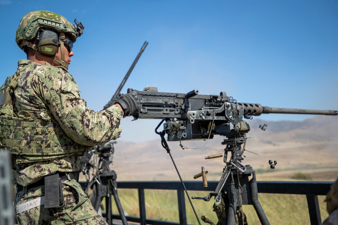 Special Warfare Combatant Crewman fires a mounted .50-caliber machine gun during a training exercise