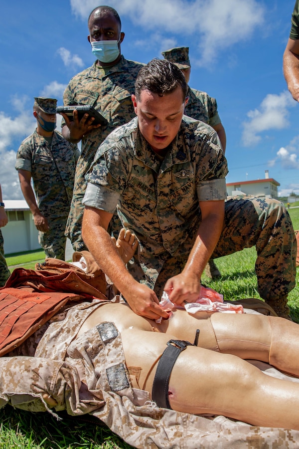 U.S. Navy Hospital Corpsman 3rd Class Justin Harvey, a Tactical Combat Casualty Care instructor with 9th Engineer Support Battalion, 3d Marine Logistics Group, instructs proper TCCC on a simulated casualty on Camp Hansen, Sept. 9, 2021. 9th ESB conducts TCCC classes to allow more Marines to become certified in combat lifesaving, a skill Lt. Col. Marcus Gillett, battalion commander of 9th ESB, plans for every Marine to have in the near future. 3d MLG, based out of Okinawa, Japan, is a forward deployed combat unit that serves as III MEF’s comprehensive logistics and combat service support backbone for operations throughout the Indo-Pacific area of responsibility. (U.S. Marine Corps photo by Lance Cpl. Courtney A. Robertson)