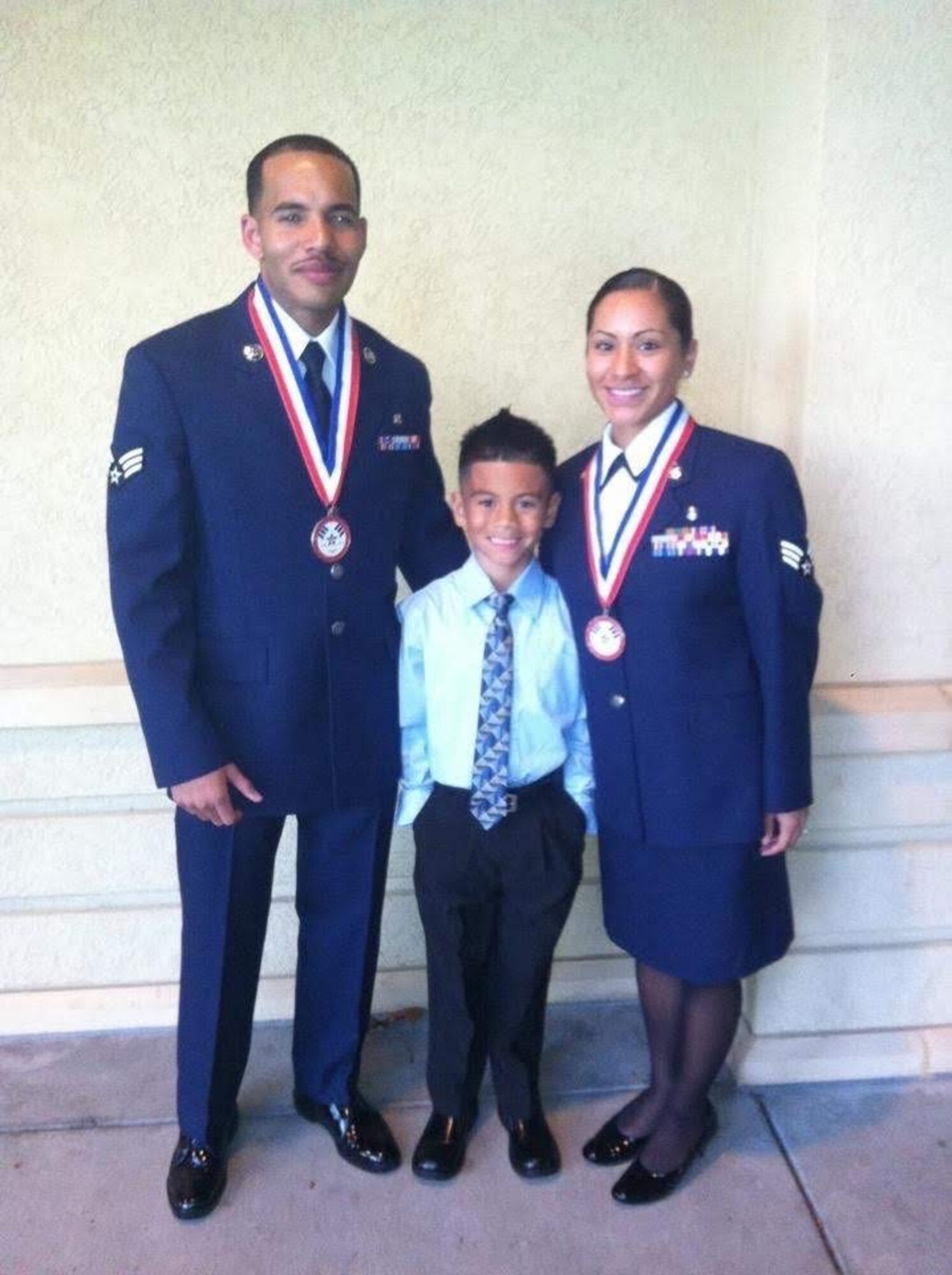 U.S. Air Force Senior Airman William Meadows Marquez, a pharmacist with the 60th Medical Group at Travis Air Force Base, Calif., stands with his wife and child after their Airman Leadership School graduation at Travis AFB in 2012. Six years later, Meadows Marquez went from student to instructor, becoming an instructor at Andersen AFB, Guam, developing himself and Airmen he mentored through his experiences and implementing updated curriculum to the course. (Courtesy photo)