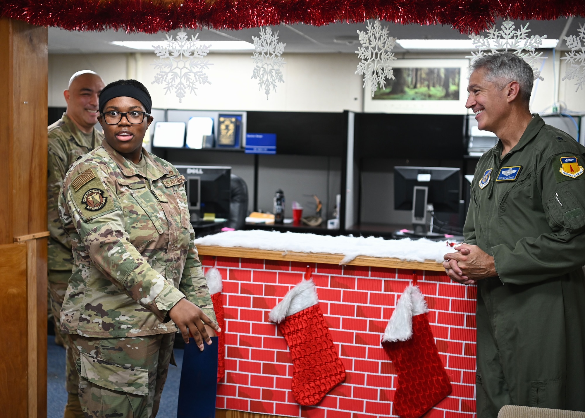 U.S. Air Force Senior Airman Aakira Ard, a customer service technician with the 36th Civil Engineer Squadron, gets a surprise visit from Brig. Gen. Jeremy T. Sloane, commander of the 36th Wing, and Chief Master Sgt. John Payne, command chief for the 36th Wing, as she received the Linebacker of the Week award at Andersen Air Force Base, Guam, Dec. 15, 2021. The Team Andersen Linebacker of the Week recognizes outstanding enlisted, officer, civilian and total force personnel who have had an impact on achieving Team Andersen’s Mission, Vision and Priorities. (U.S. Air Force photo by Senior Airman Aubree Owens)