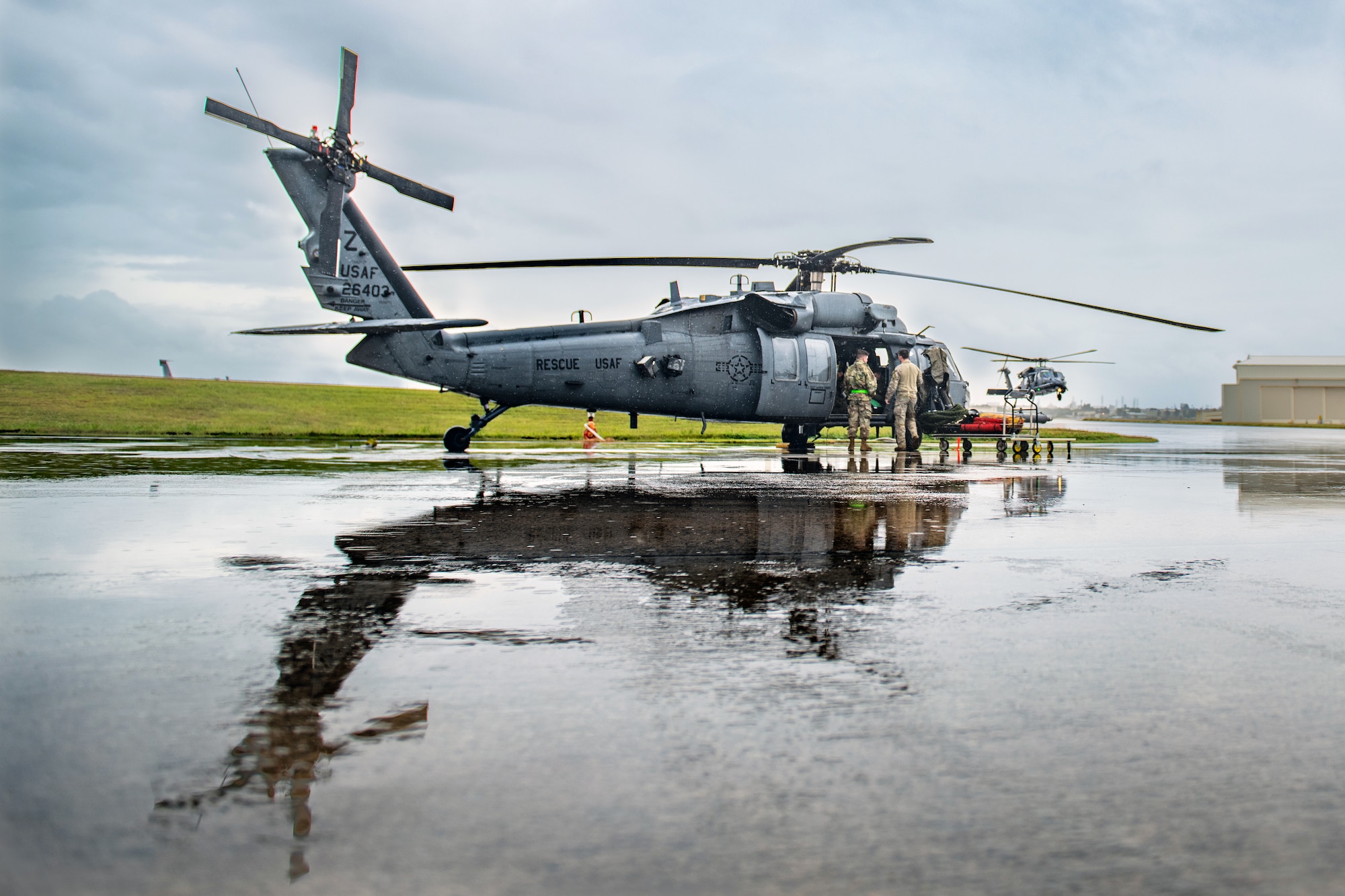 Airmen perform preflight checks on an HH-60G Pave Hawk