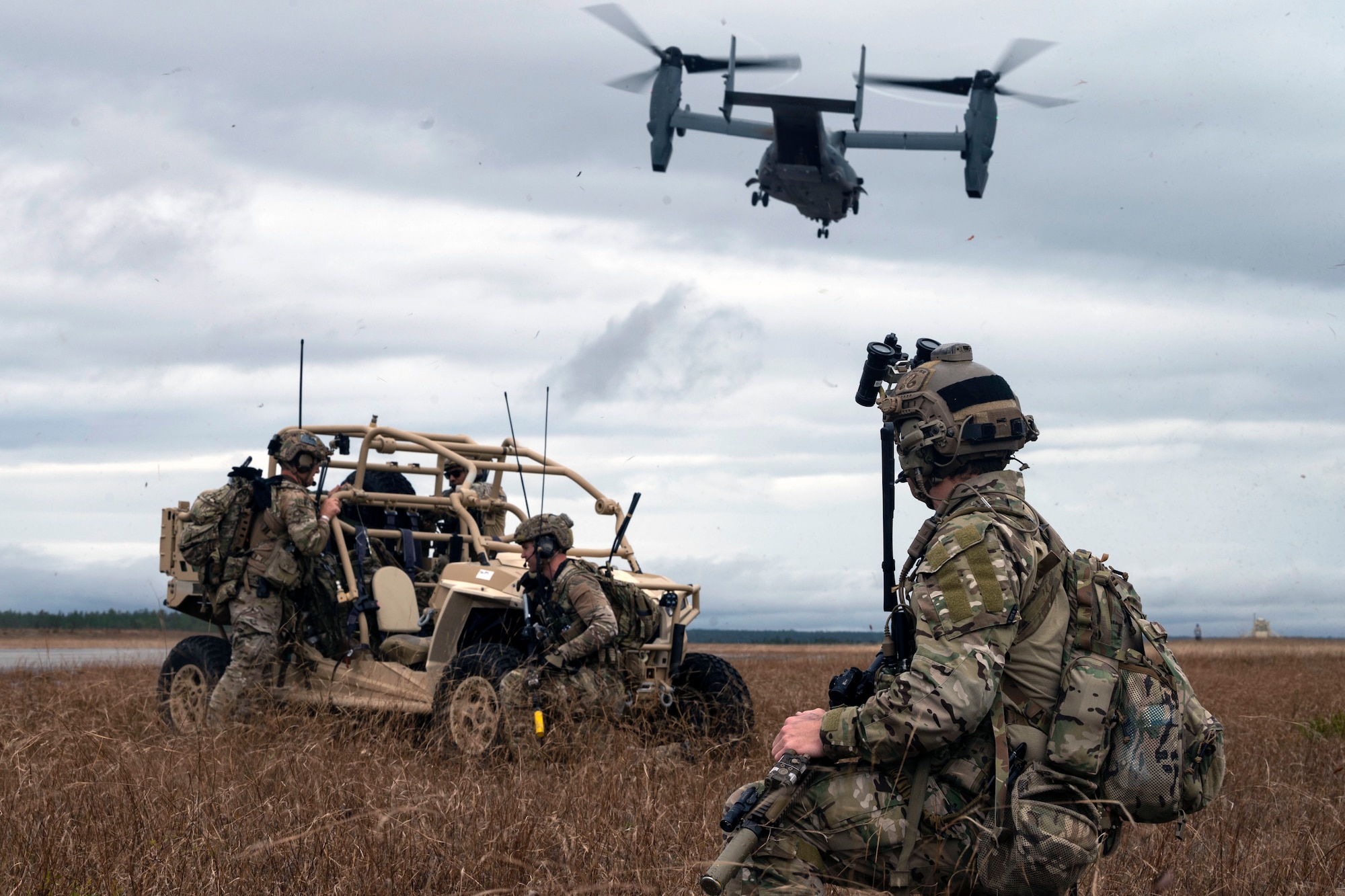 Special tactics operators watch a CV-22 Osprey