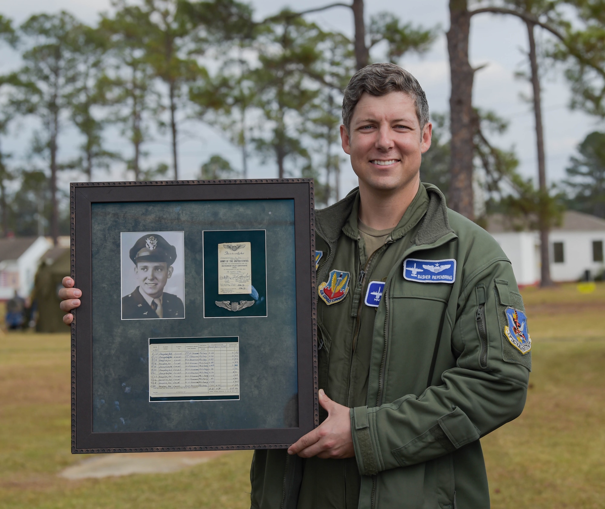 U.S. Air Force Maj. Will Piepenbring, 23rd Fighter Group assistant director of operations and A-10C Thunderbolt II pilot, holds a framed photo of his grandfather at Douglas, Georgia, Dec. 4, 2021. Retired 2nd Lt. Richard Piepenbring served during WWII as a PT-17 Stearman pilot with the 63rd Flight Training Detachment from July through December 1944. Piepenbring's grandfather inspired him to go into aviation. (U.S. Air Force photo by Senior Airman Rebeckah Medeiros)