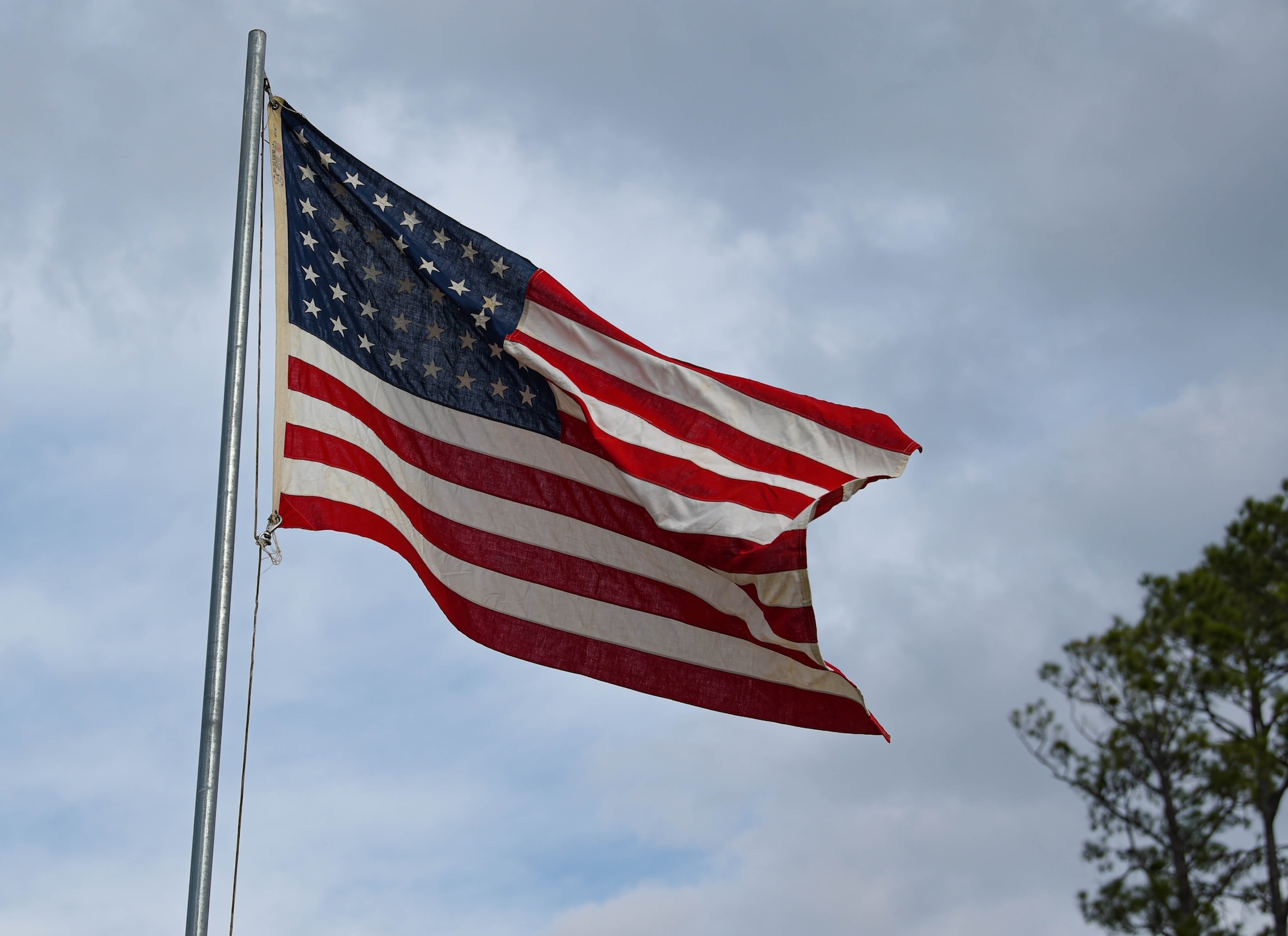A U.S. flag flies above the WWII Flight Training Museum at Douglas, Georgia, Dec. 4, 2021. A WWII living history event brought speakers from across the state of Georgia to talk about historical moments that are monumental and are not always taught in school. (U.S. Air Force photo by Senior Airman Rebeckah Medeiros)
