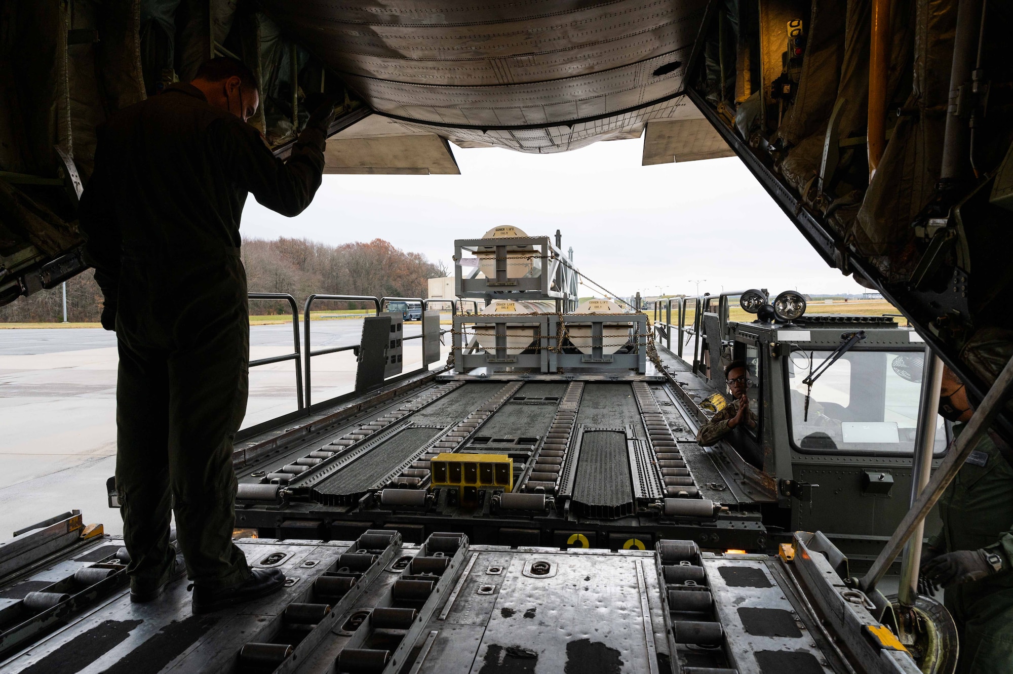 An Egyptian Air Force member marshals a K- loader to the ramp of an Egyptian Air Force C-130 Hercules during a foreign military sales mission at Dover Air Force, Delaware, Dec. 11, 2021. The United States and Egypt share a strong partnership based on mutual interest in Middle East peace and stability, economic opportunity and regional security. Due to its strategic location, Dover AFB supports approximately $3.5 billion worth of foreign military sales annually. (U.S. Air Force photo by Senior Airman Faith Schaefer)