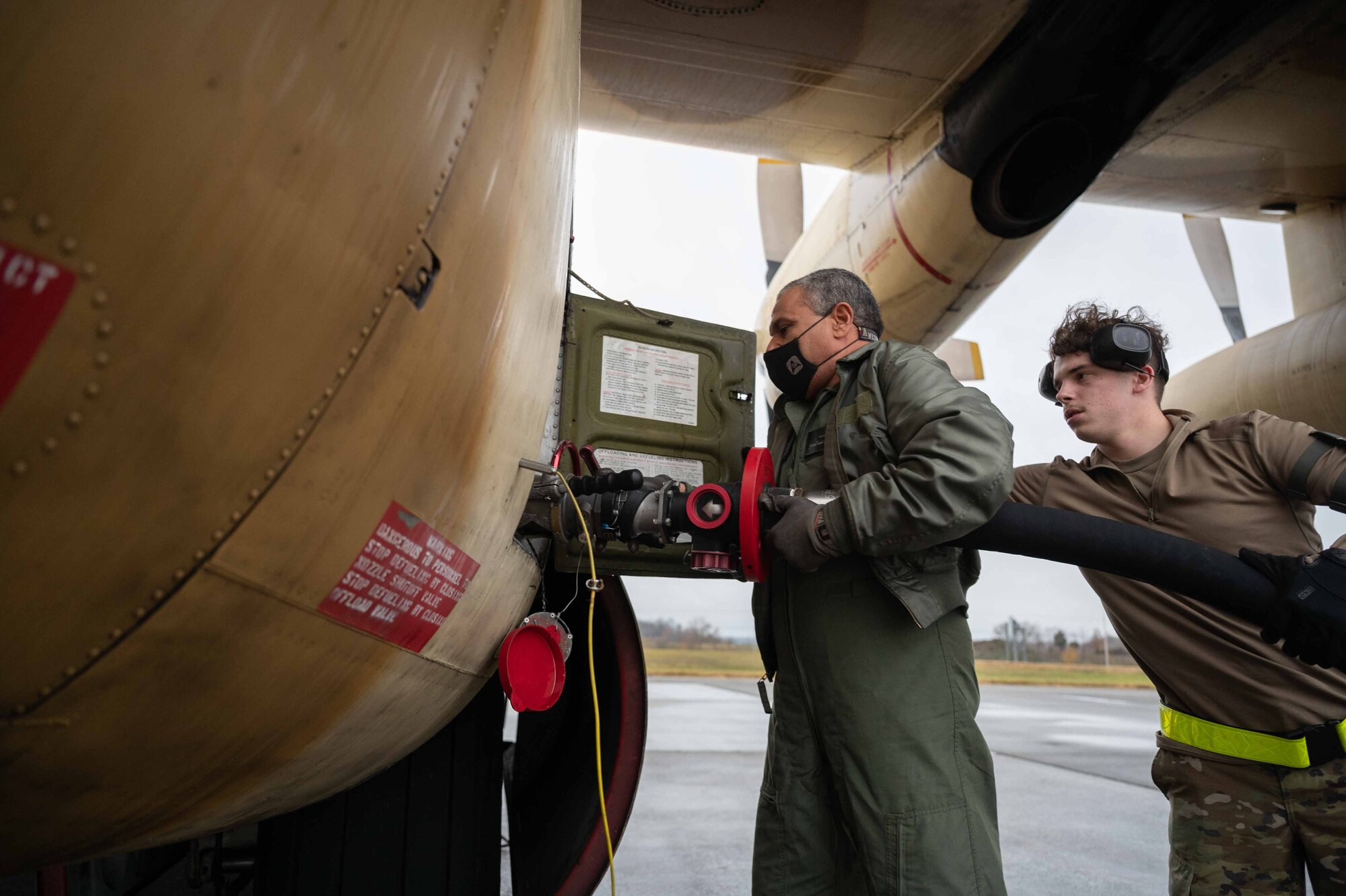 Airman 1st Class Dalton Settlemire, 436th Logistic Readiness Squadron fuels distribution operator, assists an Egyptian Air Force member refueling an Egyptian Air Force C-130 Hercules during a foreign military sales mission at Dover Air Force Base, Delaware, Dec. 11, 2021. The United States and Egypt share a strong partnership based on mutual interest in Middle East peace and stability, economic opportunity and regional security. Due to its strategic location, Dover AFB supports approximately $3.5 billion worth of foreign military sales annually. (U.S. Air Force photo by Senior Airman Faith Schaefer)