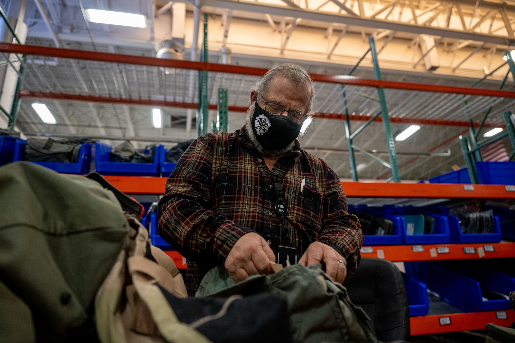 civilian inspects deployment equipment