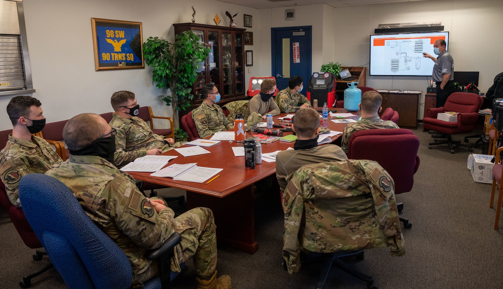 airmen at a desk