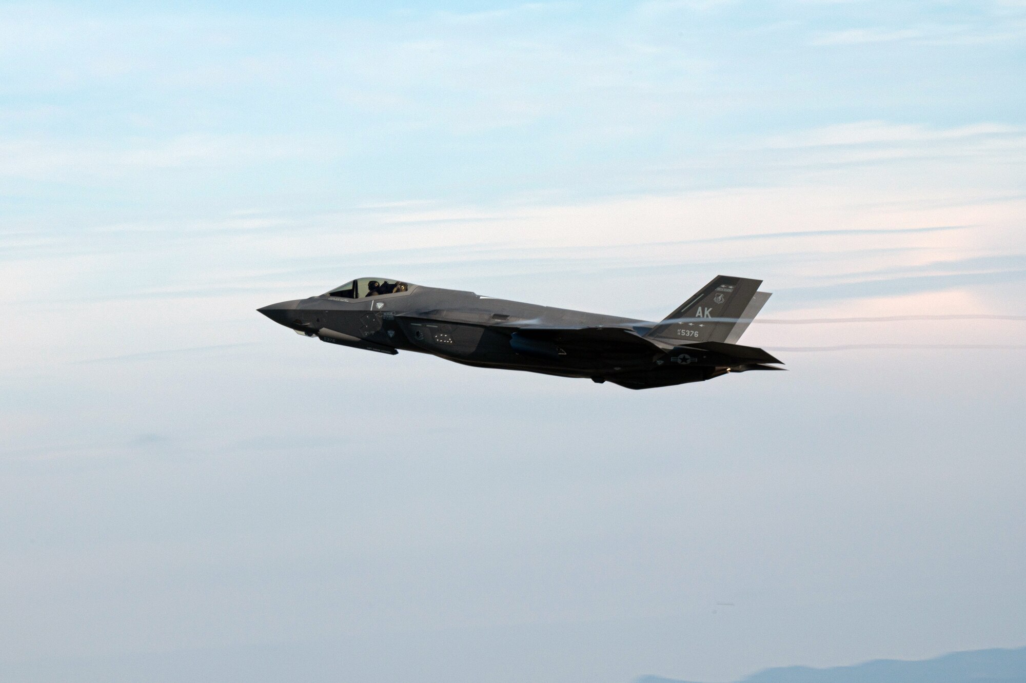 An F-35A Lightning II flies over Marine Corps Air Station Iwakuni, Japan