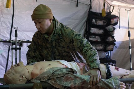 Hospital Corpsman 2nd Class Manuel Erwin, with 4th Marines, provides medical care to a simulated casualty during a mass casualty drill as part of Resolute Dragon 21.