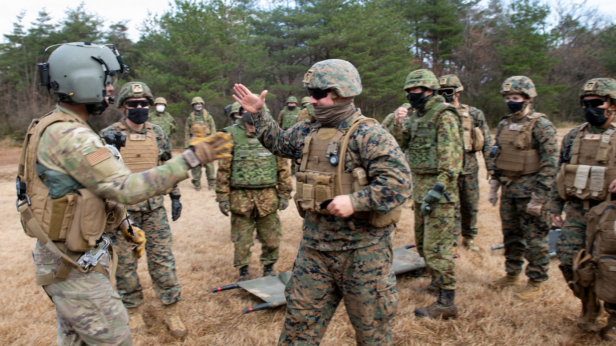 A Marine high-fives a helicopter flight enigineer.