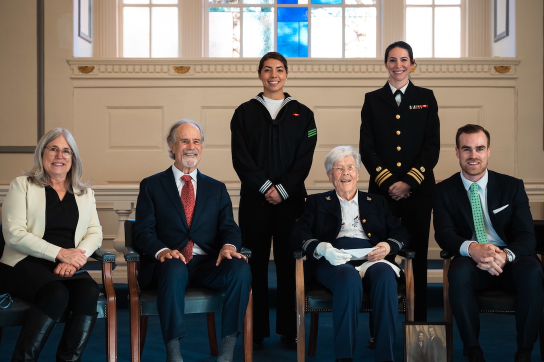 From left, Julie Koczela, Jack Koczela, Seaman Josephine Rojas of the U.S. Navy Ceremonial Guard, Ruth Koczela, Lt. Cmdr Julie Gillespy of Naval District Washington, and Luke Koczela pose for a photo.
