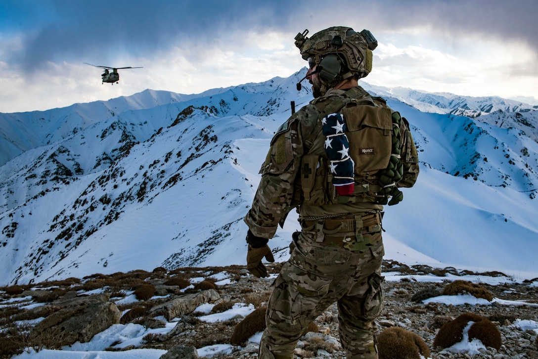 An Airman communicates with an helicopter