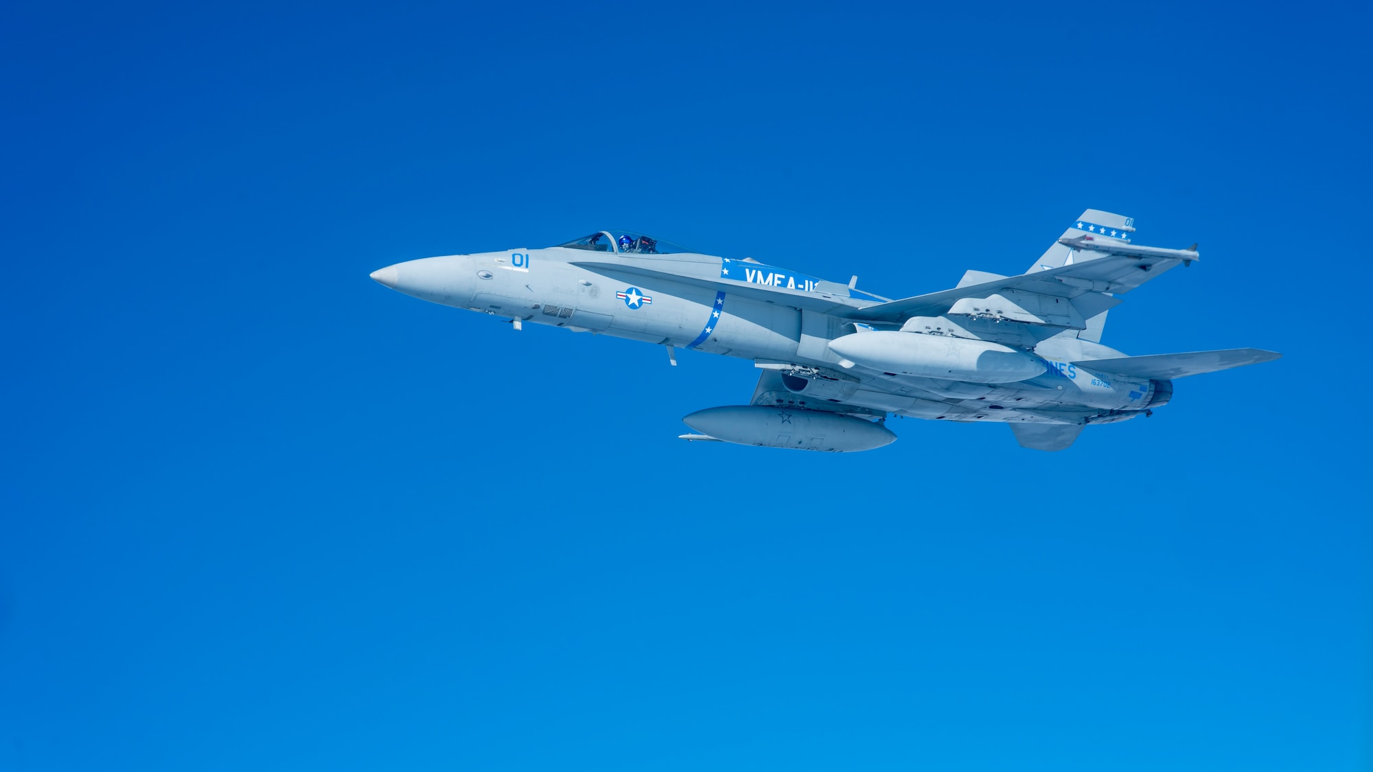 An F/A-18C Hornet flies next to a KC-135R after refueling.
