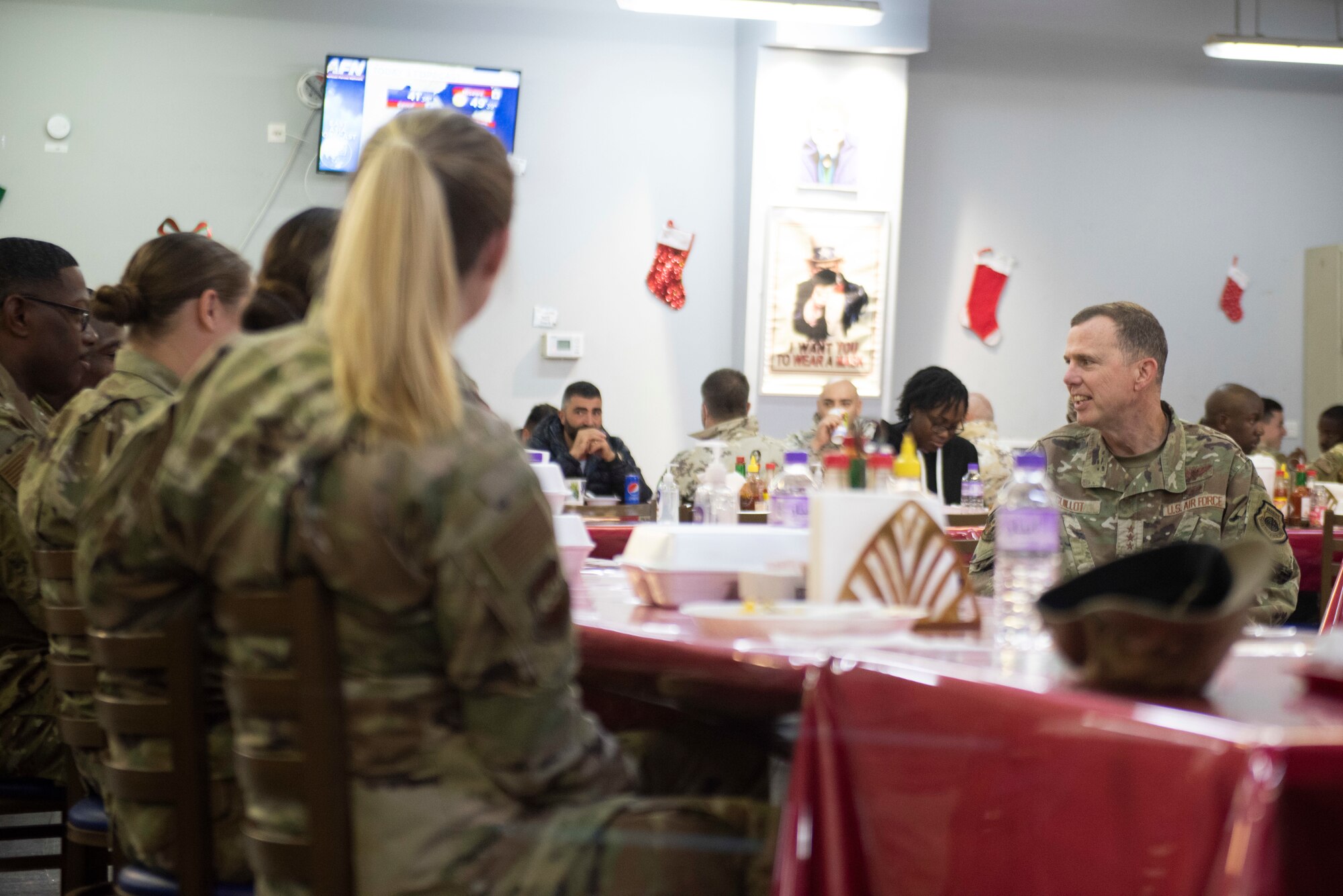 A group Airmen talk to one another
