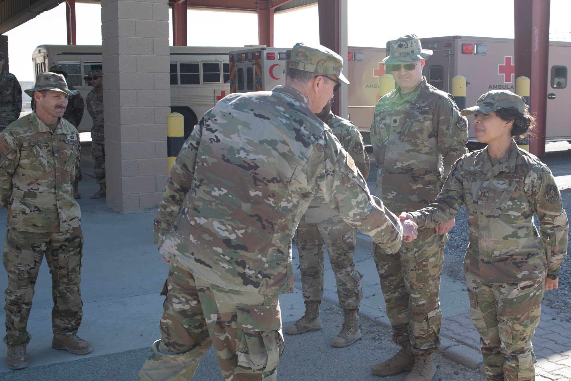 An Airman shakes another Airman's hand.