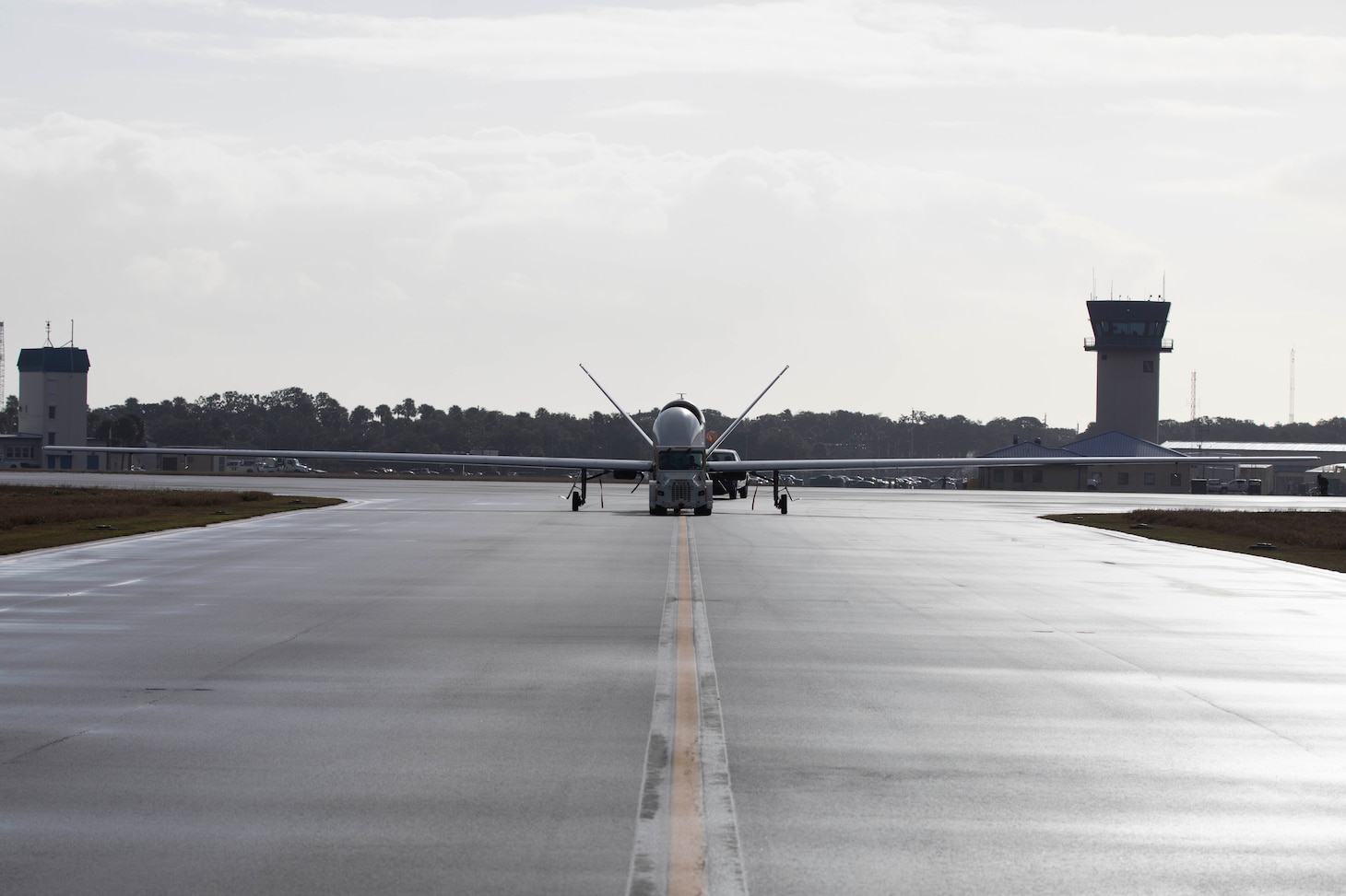 An MQ-4C Triton Unmanned Aircraft System (UAS), assigned to Unmanned Patrol Squadron 19 (VUP-19), taxis across the flight line