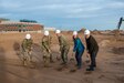 leaders shovel sand to mark the beginning of construction on a new fitness center