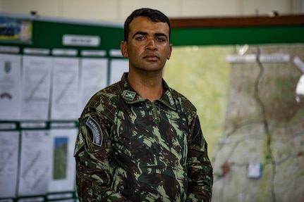 U.S. Army Soldier Staff Sgt. Shane Hayes, weapons squad leader with Bulldog Company, 1st Battalion, 187th Infantry Regiment, 3rd Brigade Combat Team, 101st Airborne Division (Air Assault) stands with his weapon during Exercise Southern Vanguard 22 in Resende, Brazil, Dec. 11, 2021. U.S. and Brazilian Army soldiers took part in the air assault exercise, which was the largest deployment of a U.S Army unit to train with the Brazilian Army forces in Brazil. (U.S Army photo by Pfc. Joshua Taeckens)