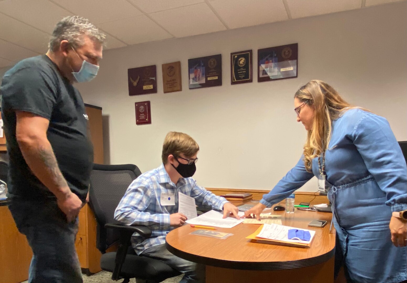 David Veale, Dakota Veale, and Erica Veale check the Space Force job list.