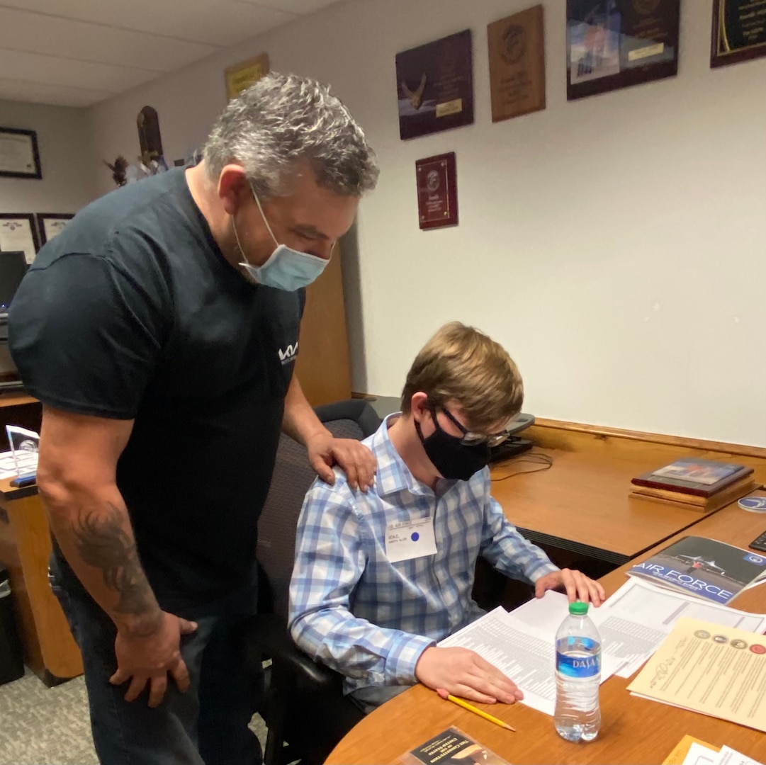 David Veale, father of Dakota Veale, checks a Space Force job list with his son.