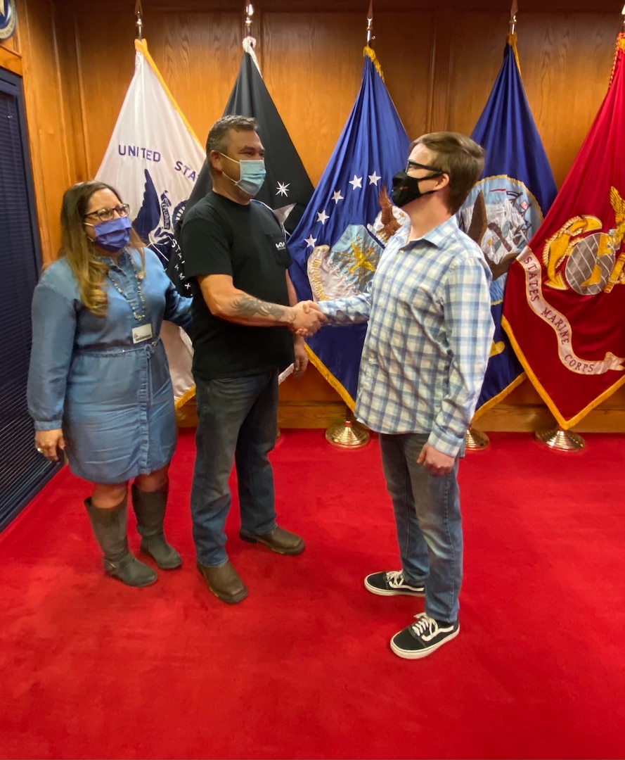 David Veale congratulates his son Dakota on his enlistment.  Far left is Erica Veale, Dakota's stepmom.