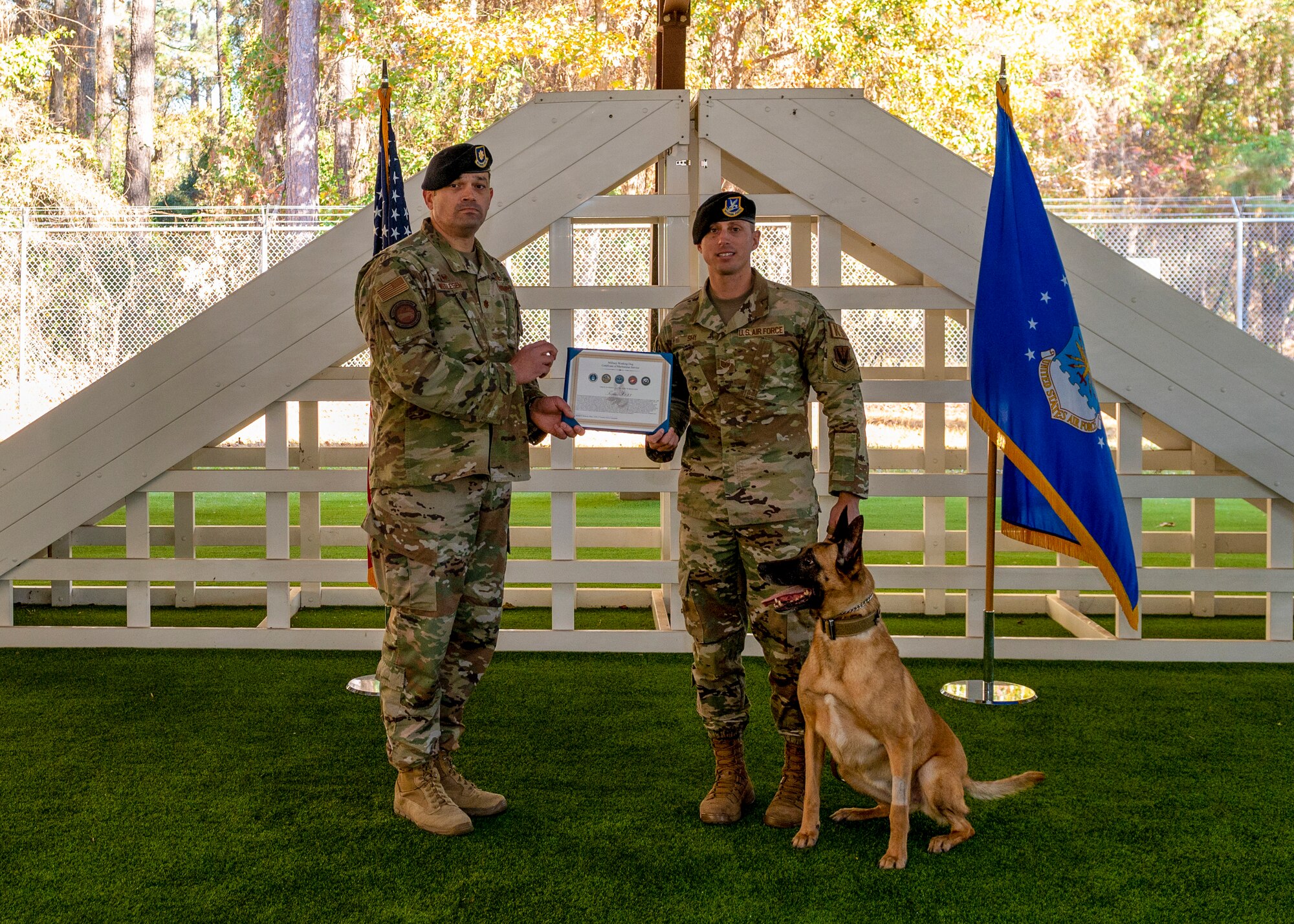 Maj. Michael Wetlesen, 4th Security Forces Squadron commander, presents Tech. Sgt. Kyle Shy, 4th SFS kennel master, with military working dog Tessa’s retirement certificate at Seymour Johnson Air Force Base, North Carolina, Nov. 19, 2021.