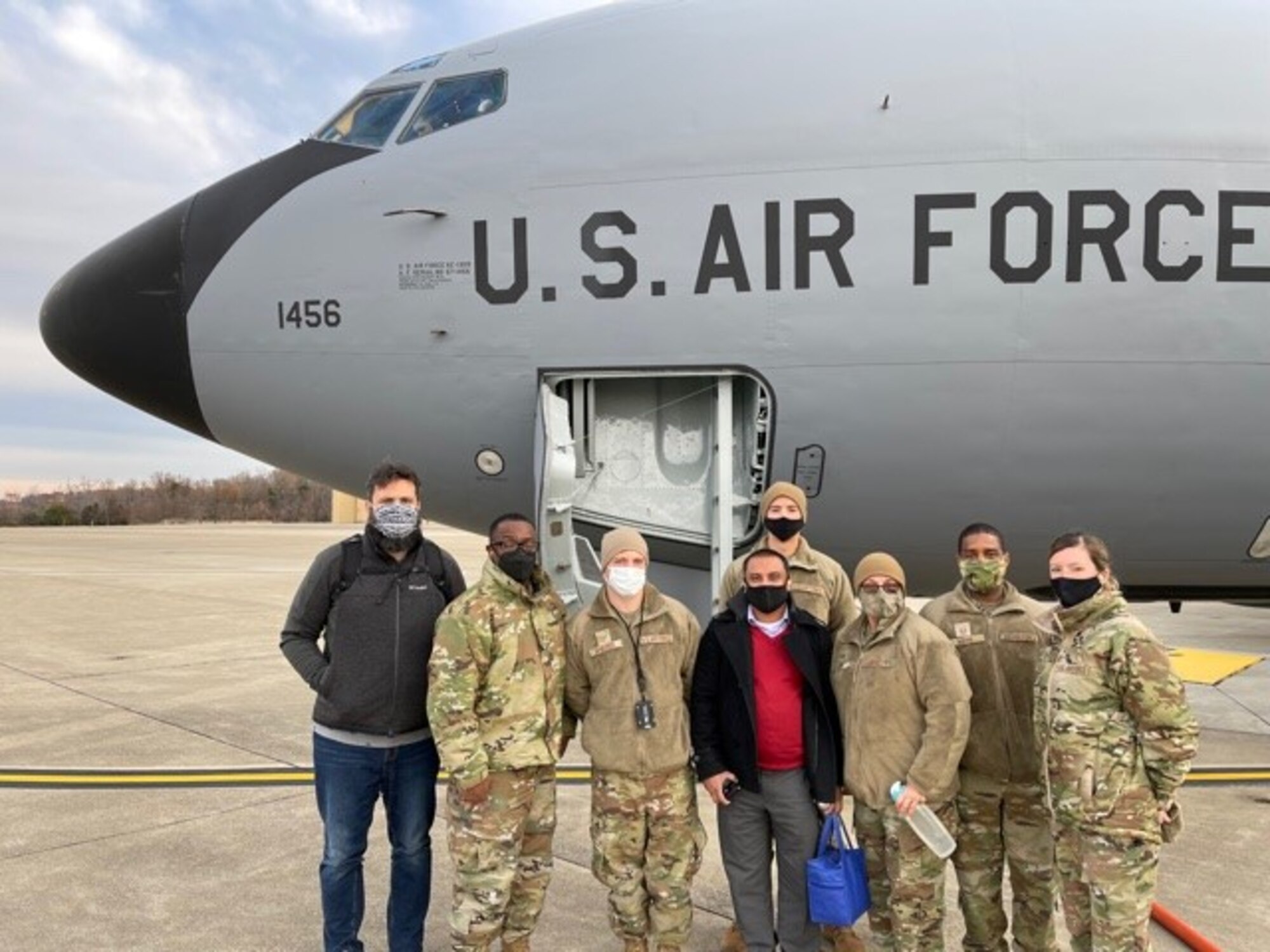Outstanding members from around the wing pose for a group photo in front a KC-135 aircraft before their orientation flight Dec. 7, 2021 at Joint Base Andrews, Md. The wing recently implemented the ‘Beyond the Fence’ program that gives Airmen the opportunity to learn and experience the mission and operations that go on beyond the fence. (Courtesy Photo)
