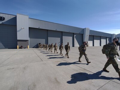 Members of Charlie Troop, 1st Squadron, 172nd Cavalry (Mountain) and Bravo Company, 572nd Brigade Engineer Battalion (Mountain), Vermont Army National Guard, begin to load onto their flight at the Army Aviation Support Facility, South Burlington, Vermont, March 10, 2021. In total, over 100 soldiers comprise these deployments to U.S. Africa Command to conduct area security support operations. (U.S. National Guard photo by Joshua Cohen)
