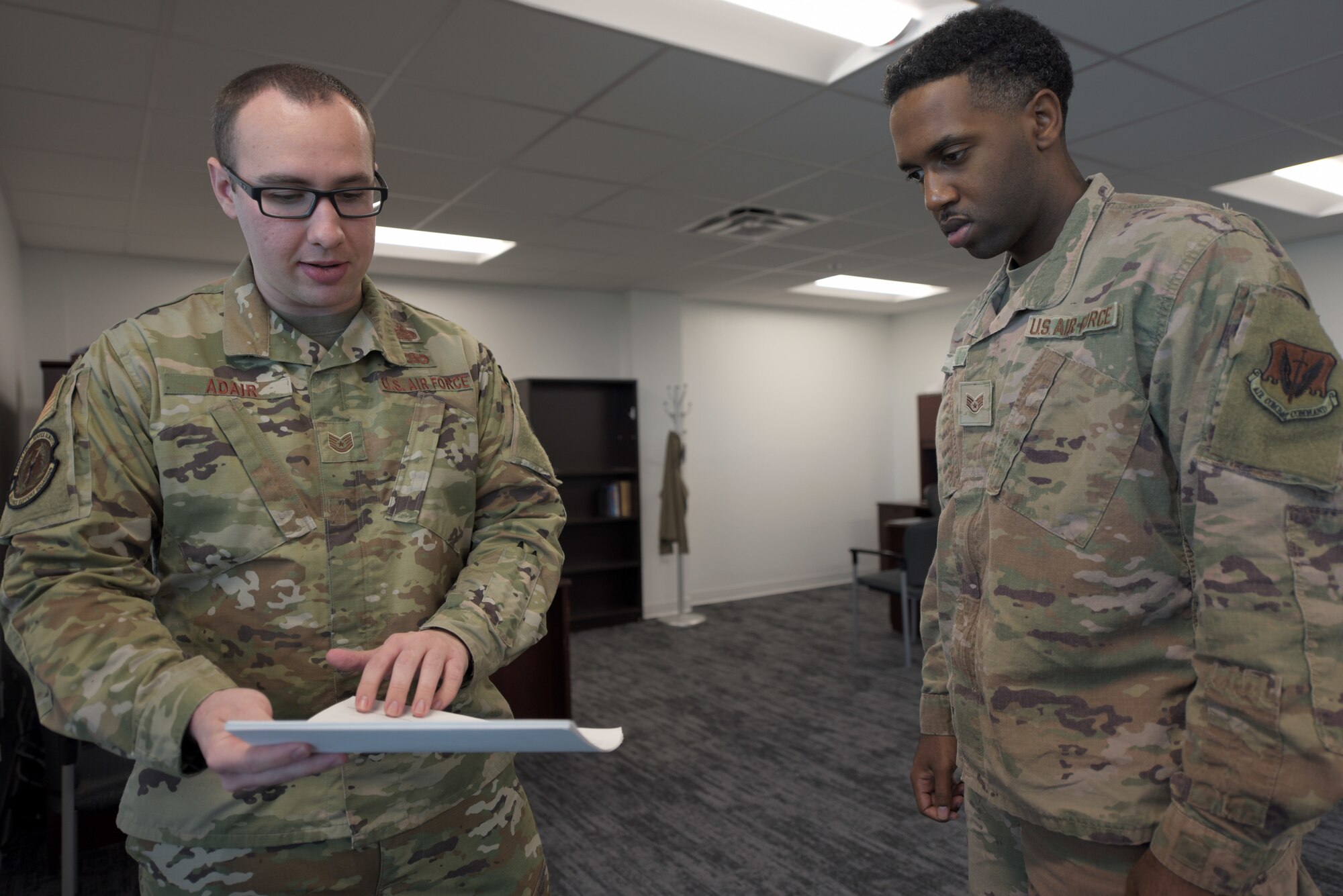 Airmen read a document