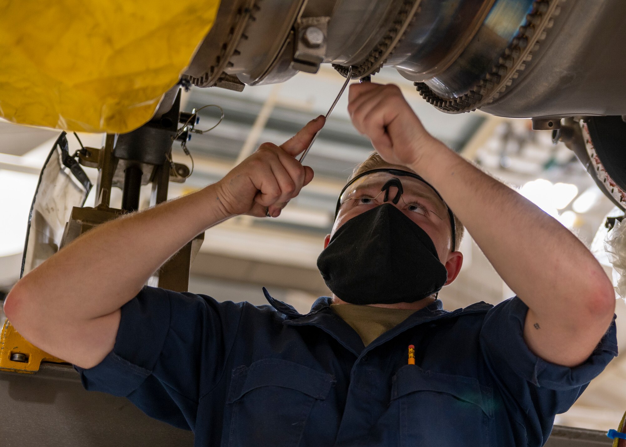 Airman 1st Class Aiden Perry, 4th Component Maintenance Squadron aerospace propulsions technicians, removes a fan drive turban module on an F-15E Strike Eagle at Seymour Johnson Air Force Base, North Carolina, Nov. 17, 2021.