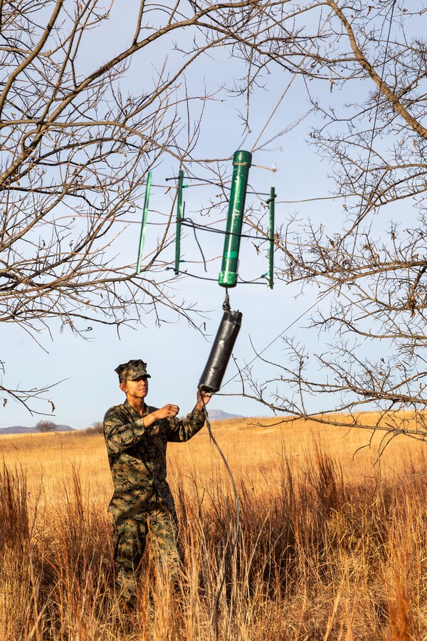 U.S. Marine Corps Lance Cpl. Aidan Groeller, a native of Apple Valley, Minn., and a radio operator with 2d Light Armored Reconnaissance Battalion, 2d Marine Division (MARDIV), sets up a Barker Williamson antenna during the 2d MARDIV High-Frequency (HF) Competition at Fort Sill, Okla., Dec. 6, 2021.