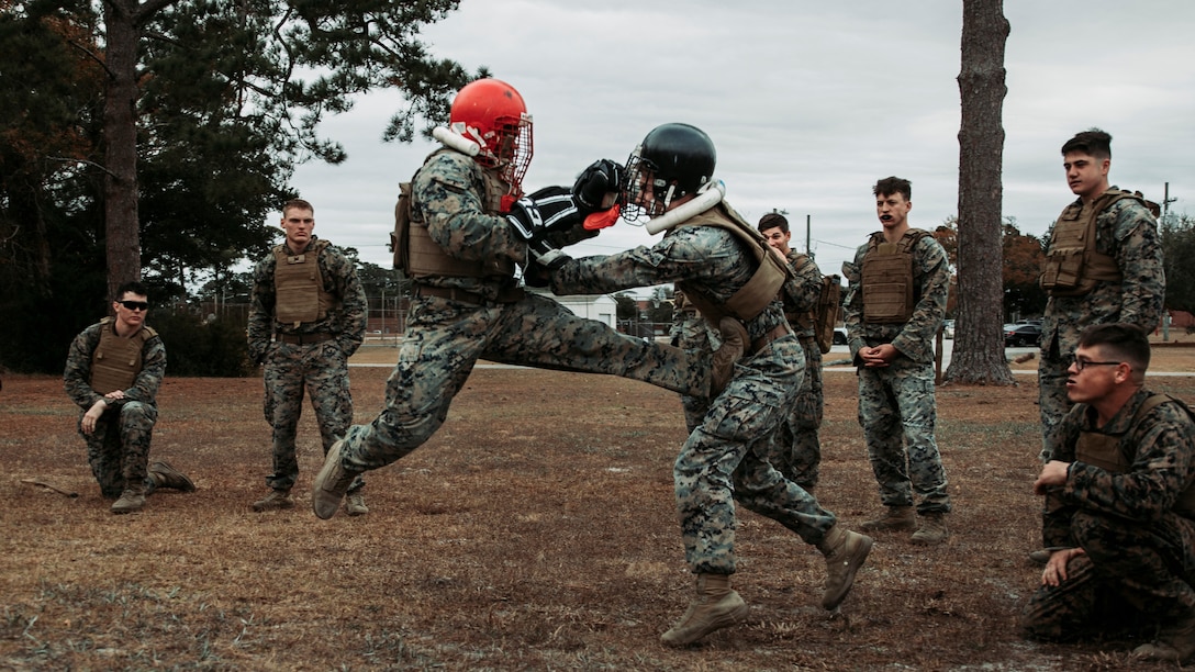 U.S. Marine Corps Sgt. Jarquis Lane, left, a native of Orlando, Fla., and an engineering equipment operator, and Cpl. Ryan Oettel, a native of Cadiz, Ky., and a combat engineer, both with 2d Combat Engineer Battalion, 2d Marine Division, engage in free sparring during Marine Corps Martial Arts Instructor (MAI) Course 123-22 on Camp Lejeune, N.C., Dec. 7, 2021. The course’s multistation culminating event challenged the students’ strength, determination, and skills needed to become an MAI. (U.S. Marine Corps photo by Lance Cpl. Jacqueline C. Arre)