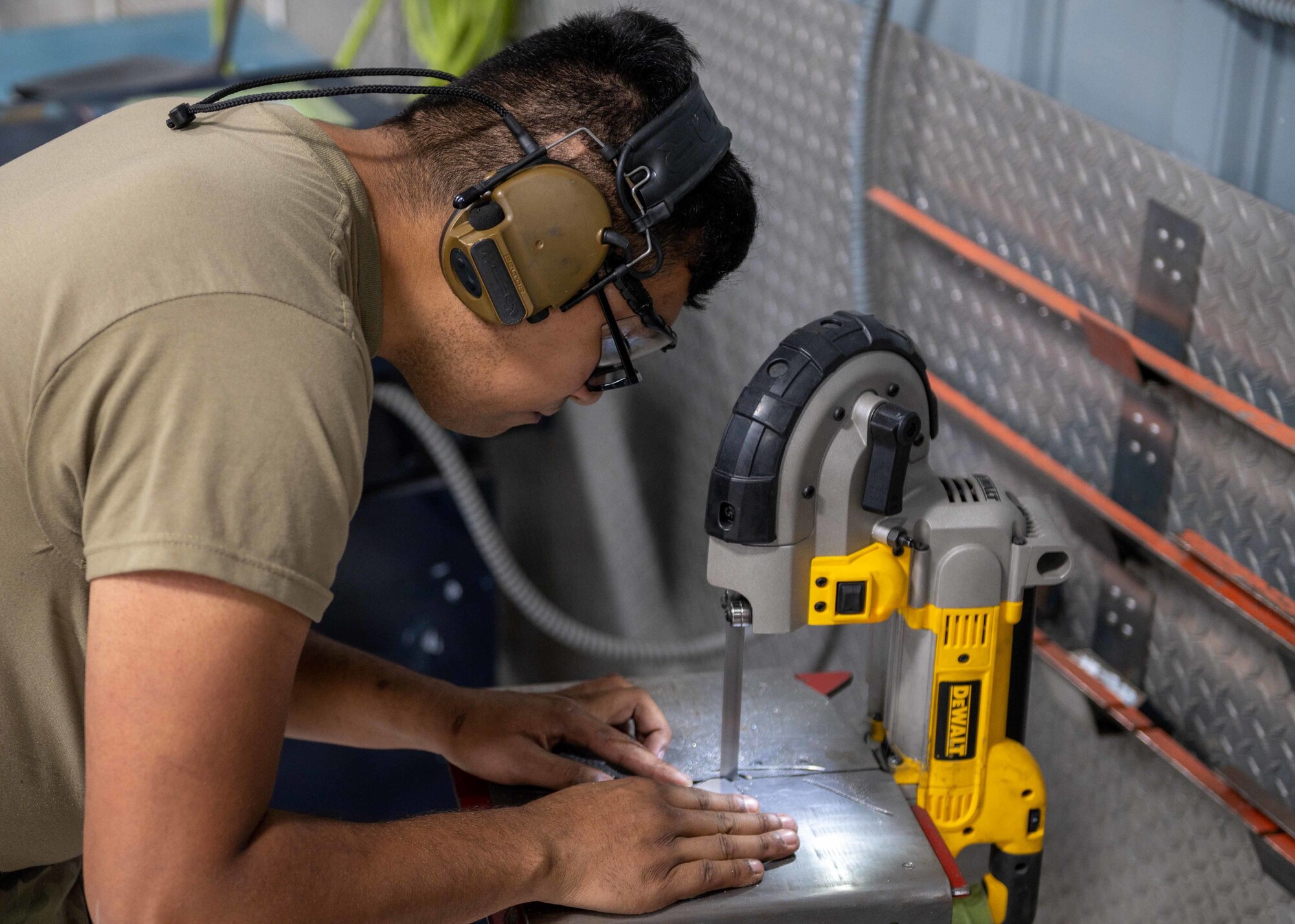 Senior Airman Alex Almanza, 4th Equipment Maintenance Squadron aircraft structure technician, uses a bandsaw to trim the panel of an F-15E Strike Eagle at Seymour Johnson Air Force Base, North Carolina, Nov. 2, 2021.