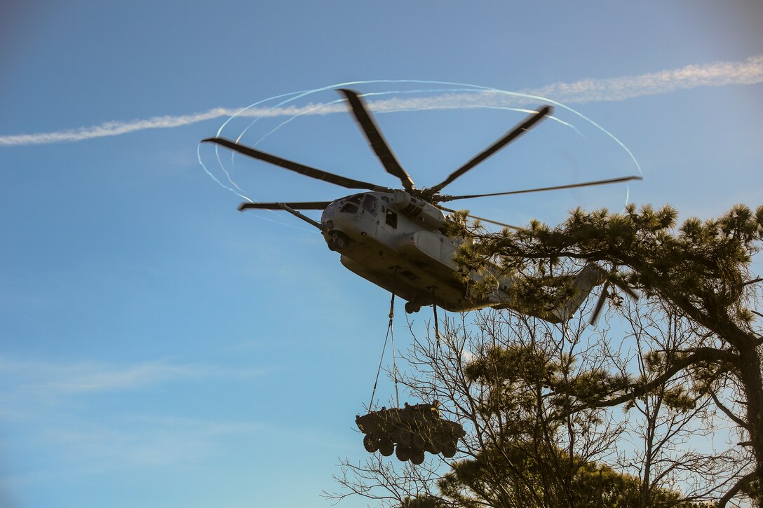 U.S. Marines with Marine Operational Test and Evaluation Squadron One (VMX-1) test the capabilities of the CH-53K King Stallion on Marine Corps Base Camp Lejeune, Dec. 16, 2021. Personnel with VMX-1 conducted surge flight operations to test the external lift capability of the CH-53K in support of amphibious operations. It can externally transport 27,000 lbs. over 110 nautical miles and has a max external lift of 36,000 lbs., three times that of the legacy "E" aircraft. The CH-53K King Stallion is a heavy-lift cargo helicopter currently being produced and tested to replace the CH-53E Super Stallion. (U.S. Marine Corps photo by Lance Cpl. Samuel Lyden)