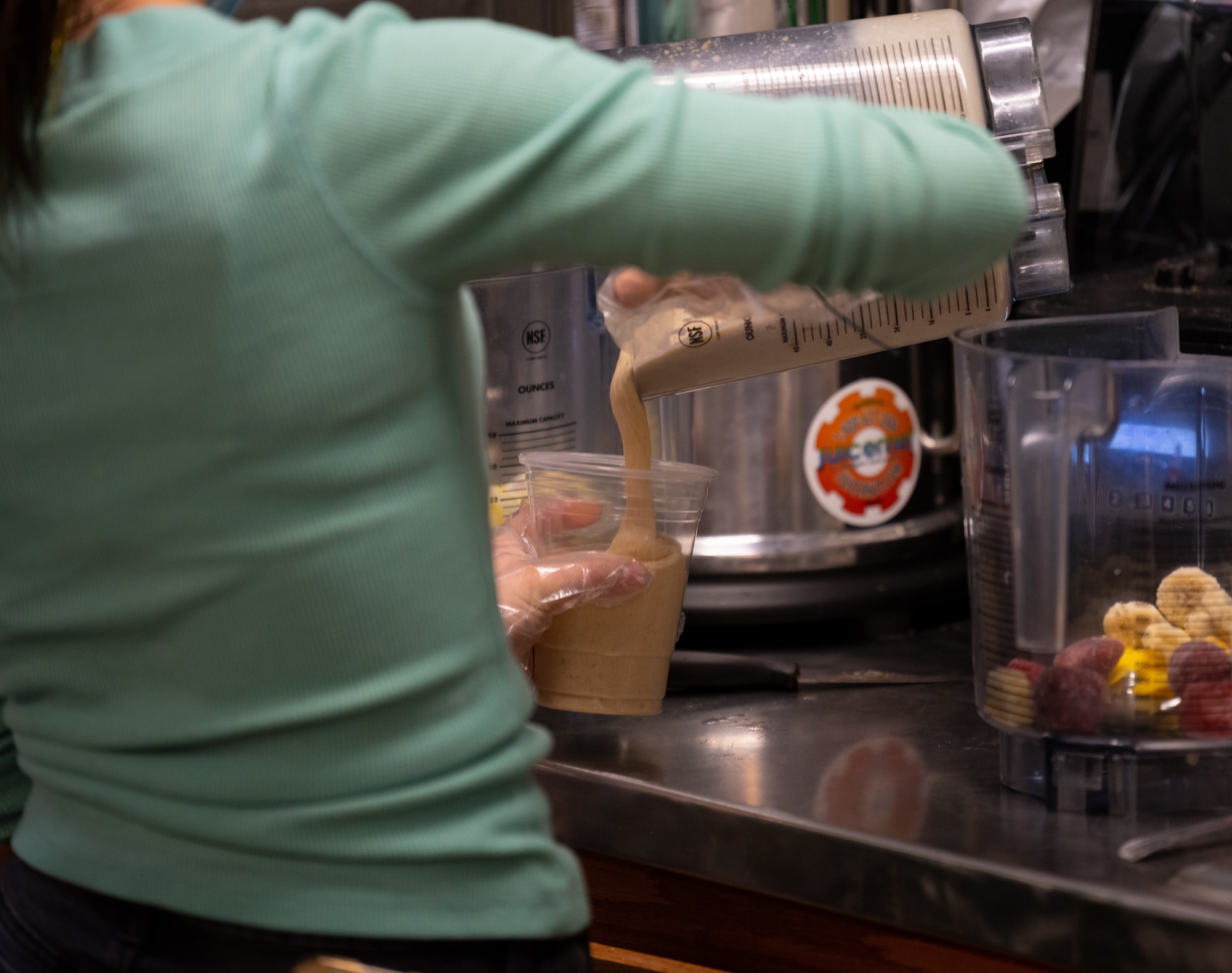 Person pours smoothie.