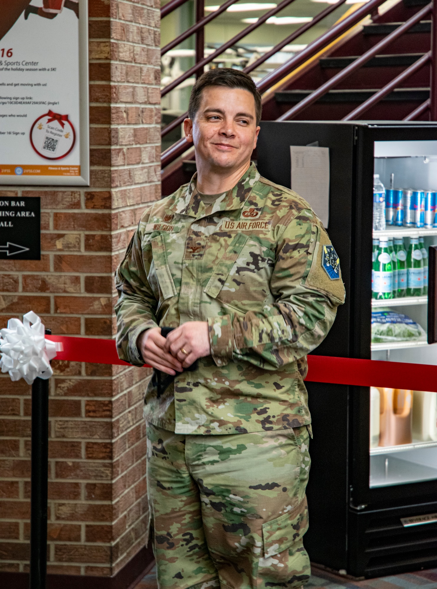 Man stands in front of ribbon