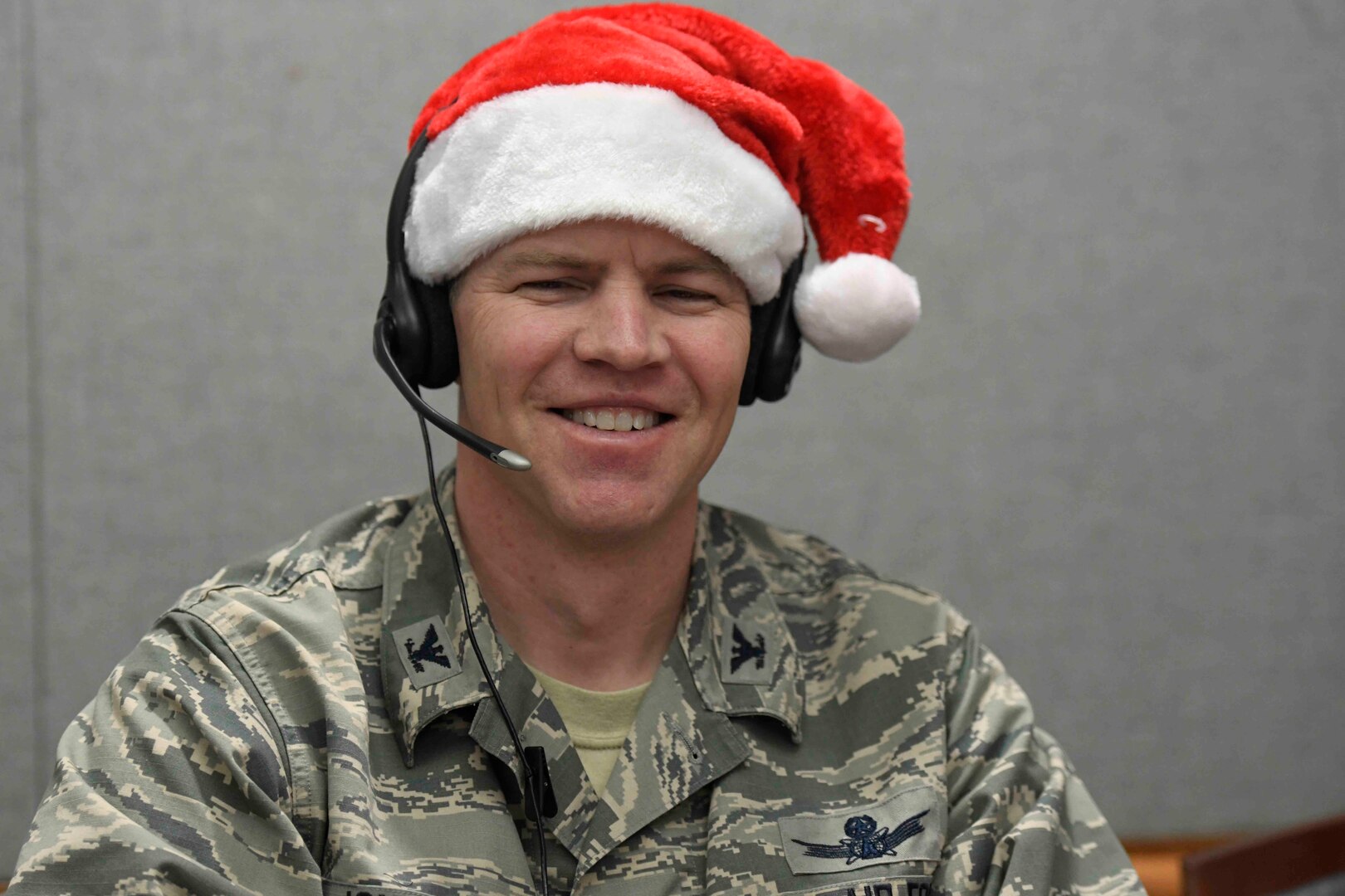 Col. Sam Johnson, 21st Space Wing vice commander, takes phone calls from children around the globe during NORAD Tracks Santa at the Operation Center on Peterson Air Force Base, Colorado, Dec. 24, 2018.
