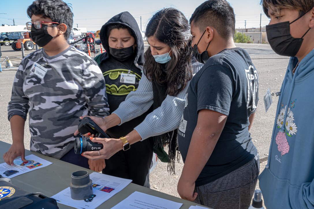 Marlen Nieblas, 412th Civil Engineer Squadron, demonstrates a FLIR camera used to capture temperature readings and used in the electrical industry to capture temperature discrepancies to students from Manzanita Elementary School in Palmdale during their visit to the 412th CES at Edwards Air Force Base, California, Dec. 8. (Air Force photo by Katherine Franco)