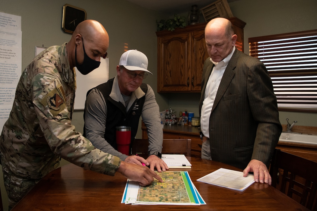 U.S. Air Force Col. Terence Taylor examines agricultural maps surrounding Cannon Air Force Base with Art Schaap, Highland Dairy owner, and John Kern, Clean Water Partnership Cannon executive director, Dec. 13, 2021, at the Highland Dairy in Clovis, New Mexico. Col. Taylor visited Schaap at his dairy in order to gain better understanding and perspective about exactly how the farm was impacted by PFAS, which the Air Force Civil Engineer Center reported to the New Mexico Environment Department in 2018. AFCEC is conducting an ongoing PFAS remedial investigation in order to find solutions for treating current water supply and preventing future contamination on and around Cannon AFB.