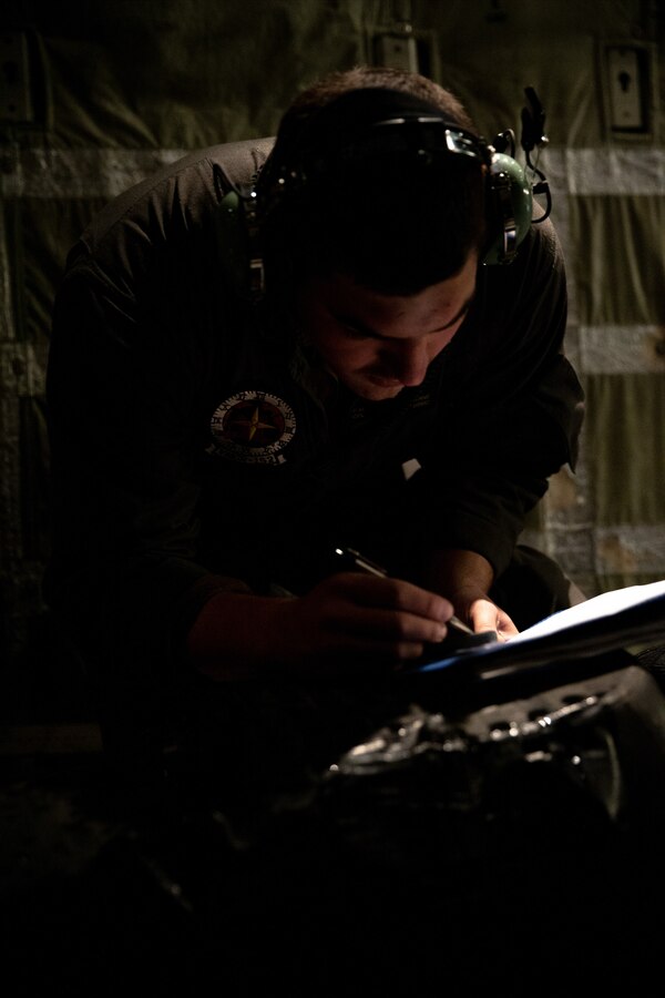 U.S. Marine Corps Cpl. Paul Keane, a crew master with Marine Aerial Refueler Transport Squadron 152, 1st Marine Aircraft Wing, records the weight of the snowmobiles and gear belonging to the Marines from Delta Company, 4th Law Enforcement Battalion, Marine Forces Reserve, aboard a KC-130J Super Hercules at Joint Base Elmendorf-Richardson, Alaska, Dec. 6, 2021. The “Alaska Marines” went to Alaska’s Northwest Arctic Borough and traveled by snowmobile and aircraft to dress as Santa Claus and deliver toys to children in remote villages belonging to Alaskan Natives in support of the Marine Forces Reserve Toys for Tots program. (U.S. Marine Corps photo by Cpl. Brendan Mullin)
