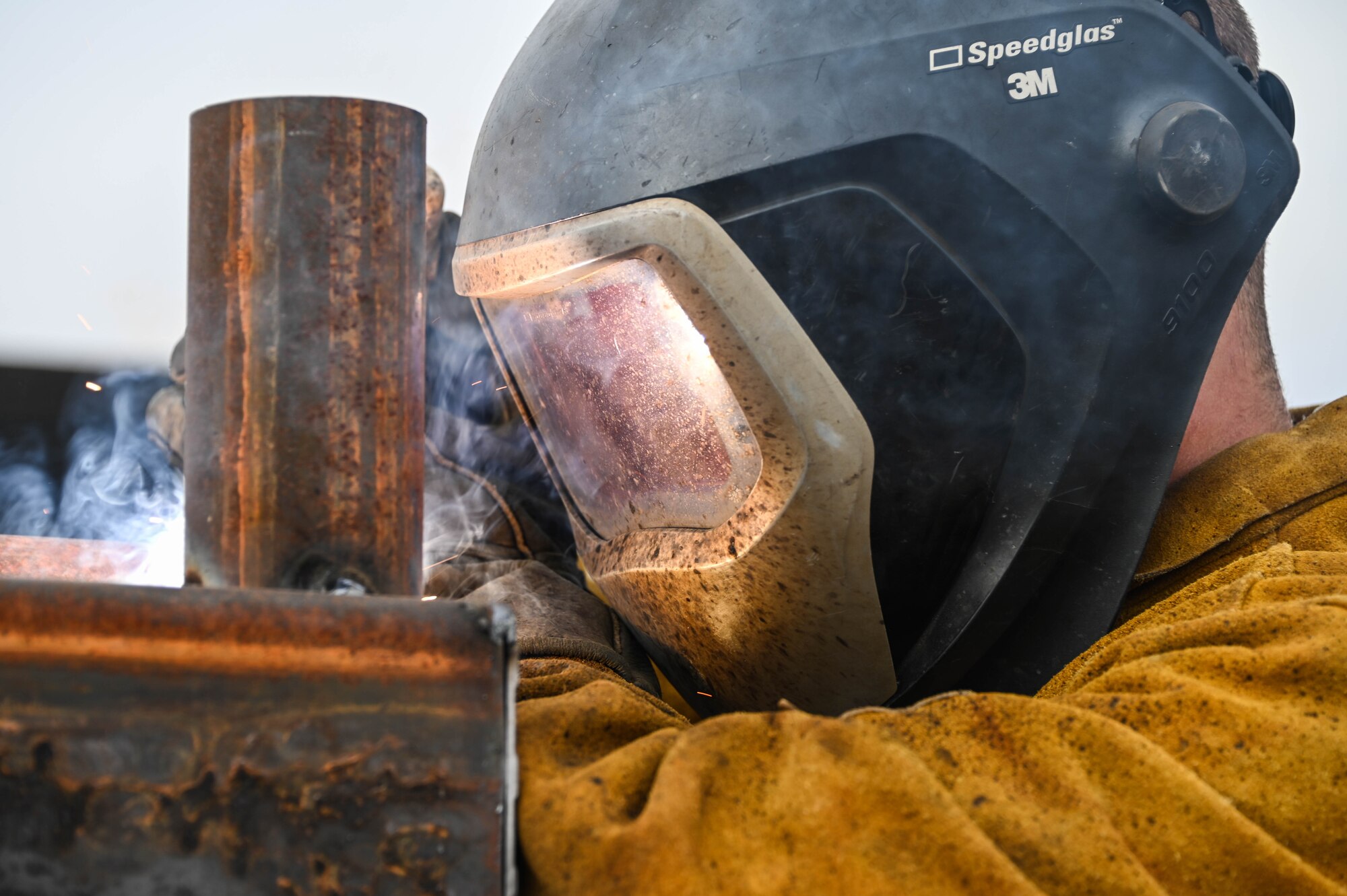 U.S. Air Force Airman 1st Class Blake Silvis, 97th Civil Engineering Squadron (CES) structural craftsman, welds a part of a fence at Altus Air Force Base, Oklahoma, Dec. 17, 2021. This is the seventh gate designed and built by the 97th CES on base. (U.S. Air Force photo by Airman 1st Class Kayla Christenson)